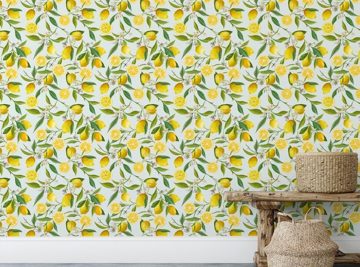 a wallpaper with lemons and leaves on it in a white room next to a wooden bench