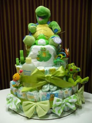 a diaper cake that is sitting on top of a table with stuffed animals around it