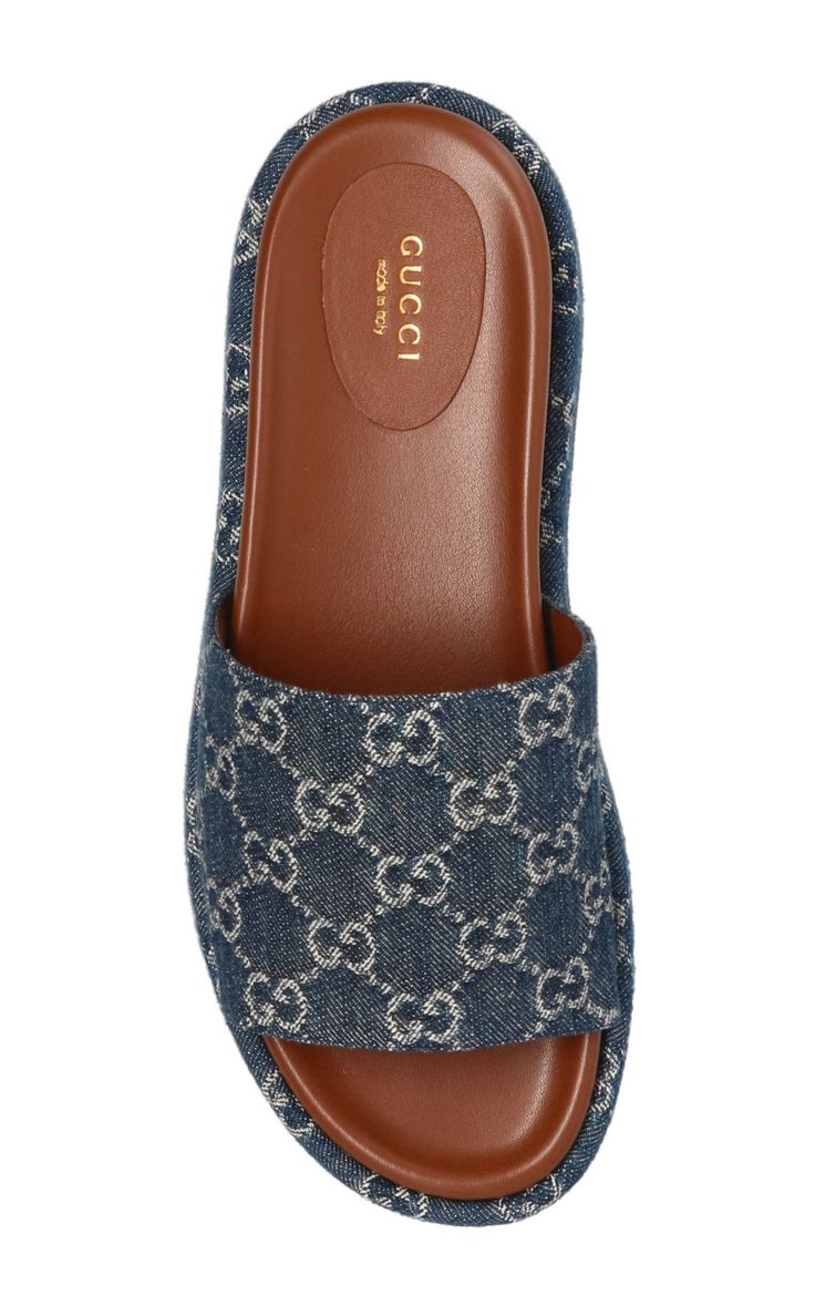 These blue Gucci Angelina 55 platform sandals are made in Italy. They feature a canvas design with signature GG Supreme patterning, a brown leather insole and a 55 mm flatform. Upper: Cotton, LeatherLining Composition: Leather 100%Sole Composition: Rubber 100%Slip-onFits true to sizeHeel height: 2.2" /5cmMade in Italy Luxury Platform Slip-on Sandals, Luxury Leather Platform Slides, Luxury Slides With Platform And Round Toe, Blue Leather Gucci Sandals, Luxury Slip-on Platform Sandals, Gucci Luxury Sandals With Cushioned Footbed, Luxury Gucci Sandals With Cushioned Footbed, Luxury Gucci Slides With Rubber Sole, Luxury Platform Slides For Summer