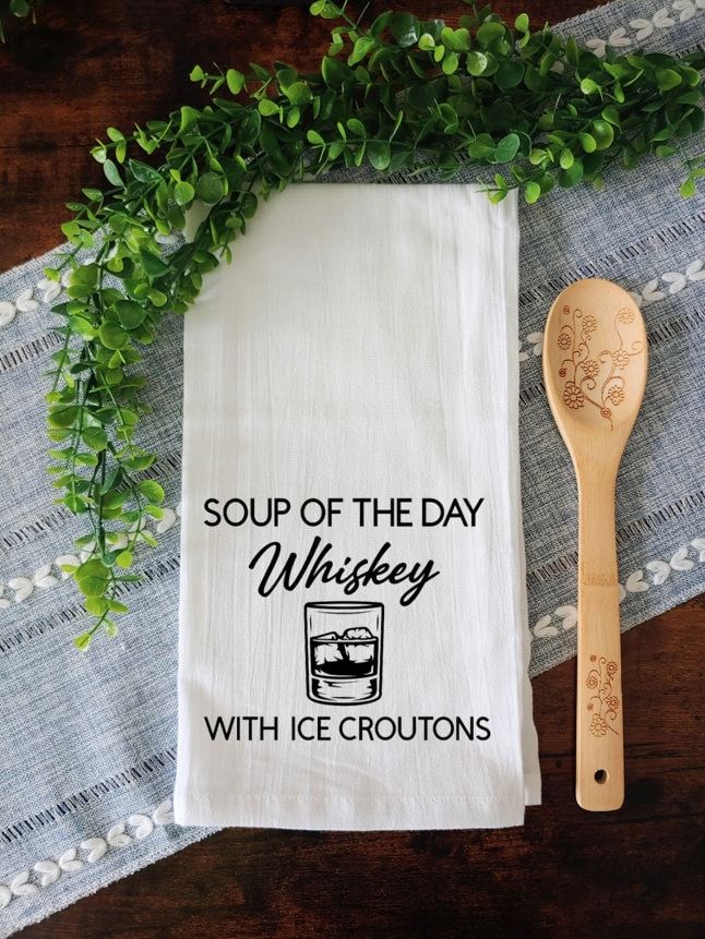 a tea towel that says soup of the day whiskey with ice croutons