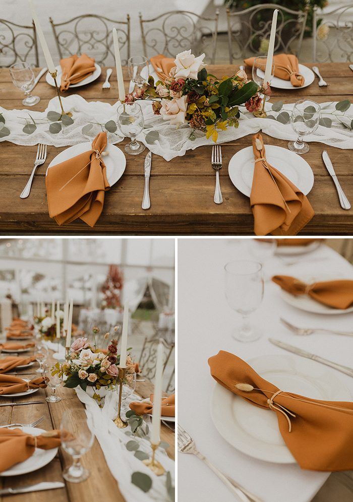 the table is set with orange napkins and place settings