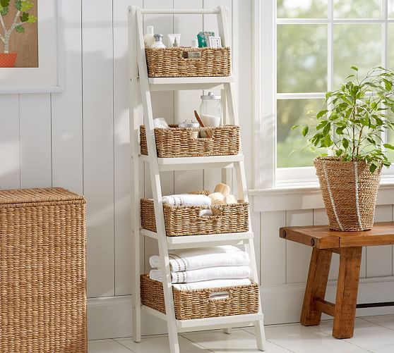 a white ladder is next to a window with wicker baskets on the bottom shelf