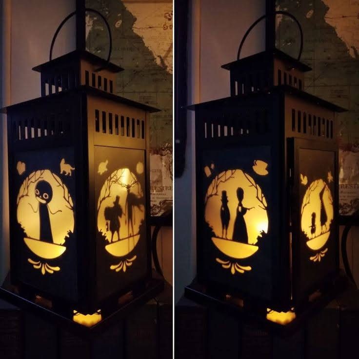 two lanterns with the silhouettes of people on them