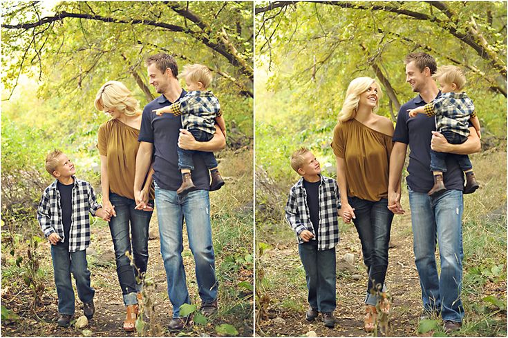 the family is walking through the woods with their son and daughter in his arms, holding each other's shoulders