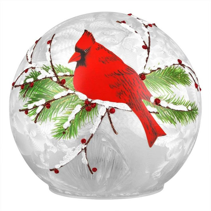 a glass ornament with a cardinal on it