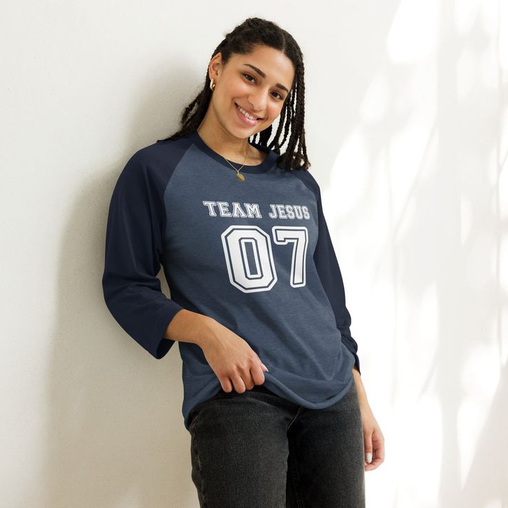 This Team Jesus Jersey Shirt is the perfect Christian shirt for any sports fan! It's a sporty stylish way to share your faith and heart for Jesus with anyone! Plus it's super soft and comfy. Whether your heading to your favorite sports game, running errands or a weekend get away, this cute Team Jesus shirt is a comfy casual Jesus shirt for any occasion. A stylish spin on the classic baseball raglan. The combed cotton blend makes it super soft, comfortable, and lightweight. You don’t even have to Sporty Navy Pre-shrunk Tops, Casual Jersey T-shirt For Game Day, Collegiate Navy Tops For Baseball Season, Collegiate Navy Top For Game Day, Navy Tops With Letter Print For Baseball Season, Navy Letter Print Tops For Baseball Season, Navy Varsity Top For College, Navy Tops For Game Day During Sports Season, Navy Sporty Tops For Game Day