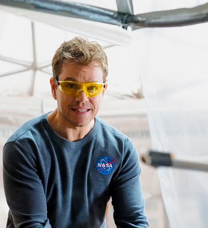 a man wearing yellow sunglasses sitting down