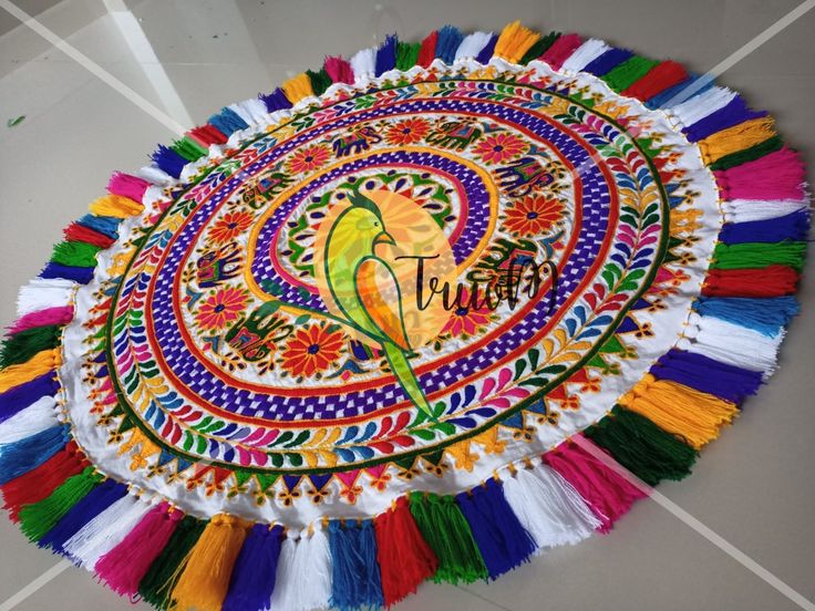 a colorfully decorated table top with the word happy on it and tassels