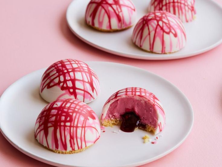 three white plates topped with pink and red desserts