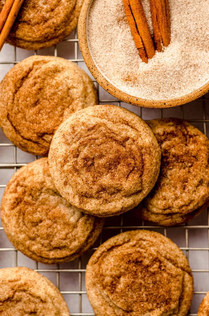 cinnamon sugar cookies on a cooling rack with cinnamon sticks