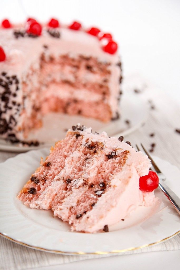 a piece of cake on a plate with a fork in front of it and one slice missing