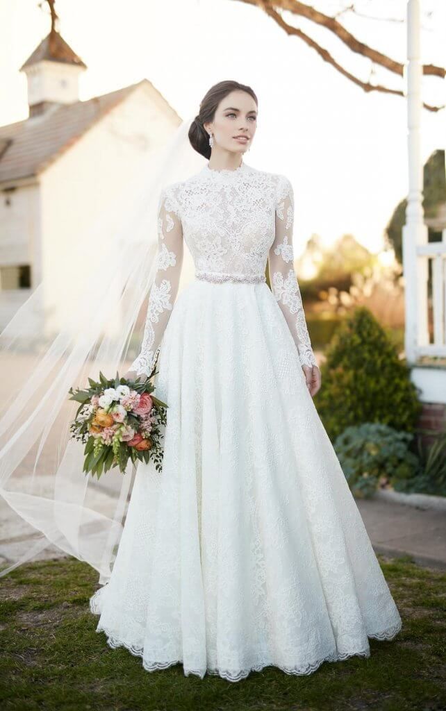 a woman in a wedding dress standing on the grass