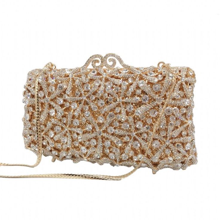 Description: ROSY Clutch is the perfect accessory for any formal occasion. This elegant piece features a crystal clutch design, ensuring it will make a sophisticated statement wherever it goes. Perfect for pairing with any ensemble, the ROSY Clutch adds a touch of glamour to any look. Color - Gold | Lining Material: Synthetic Leather Detachable Chain Included Approximate Size: 17-1/2cm (L) x 5cm (W) x 10cm (H) Crystal Evening Bag With Bling For Party, Crystal Bling Evening Bag For Party, Crystal Clutch With Rhinestones For Party, Crystal Evening Bag With Rhinestones For Parties, Glamorous Crystal Clutch For Party, Chic Embellished Crystal Evening Bag, Glamorous Party Clutch With Bling, Glamorous Crystal Clutch For Prom, Glamorous Crystal Evening Bag For Prom