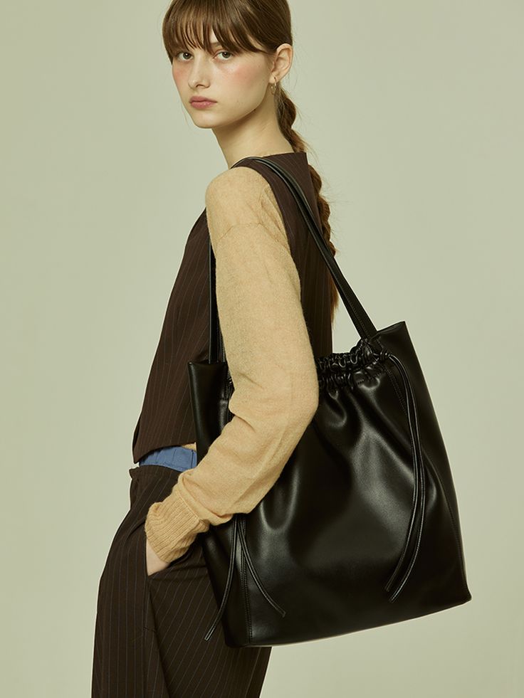 Editor's NoteOTHER TEMPO's practical designed bags can be matched with various trendy and casual outfits.- Soft vegan leather creates a natural fit- Big size that can store 16 in. laptop- Magnetic closing detail- Wrinkle design on the entranceMeasurements(in.)- Size: 13.39 in. * 15.35 in. * 3.94 in.- Strap: 24.41 in.Composition & Care- Vegan Leather / Twill- Avoid direct heat and moisture- The leather may have fine scratches and wrinkles- Professional cleaning is neededDesigner- by OTHER TEM Rectangular Casual Hobo Bag For Work, Casual Rectangular Hobo Bag For Work, Casual Black Laptop Bag With Double Handle, Chic Leather Laptop Bag With Large Capacity, Chic Soft Leather Shoulder Laptop Bag, Chic Soft Leather Laptop Shoulder Bag, Chic Large Capacity Leather Laptop Bag, Casual Leather Laptop Bag With Large Capacity, Chic Leather Laptop Bag For Shopping