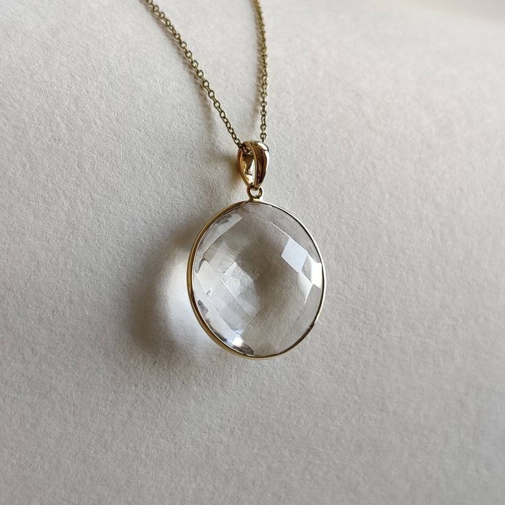 ITEM DESCRIPTION: >>The pendant is made from Solid 14K Yellow Gold. Gemstone used is absolutely natural and ethically sourced. >>Natural Clear quartz briolette in Round shape and bezel setting is studded on it with utmost precision. >>This is a minimalist design and is absolutely hassle-free and everyday jewelry. Gem: Clear quartz Gem size: 20 mm, round Gem weight: 14.58carats Gold purity: 14K (58.33% approx.) Gold weight: 0.61 grams Gross weight: 3.53 grams The Gold purity is guaranteed and it Faceted Diamond Necklace For Anniversary, Elegant Faceted Gemstones In Sterling Silver, Elegant Faceted Sterling Silver Gemstones, Clear Gemstone Pendant Jewelry, Elegant Gemstones With Vvs Clarity And Round Cut, Elegant Faceted Gemstones For Formal Occasions, Modern White Gold Gemstones For Gift, Elegant Round Faceted Necklace, Elegant Round Cut Gemstones With Vvs Clarity