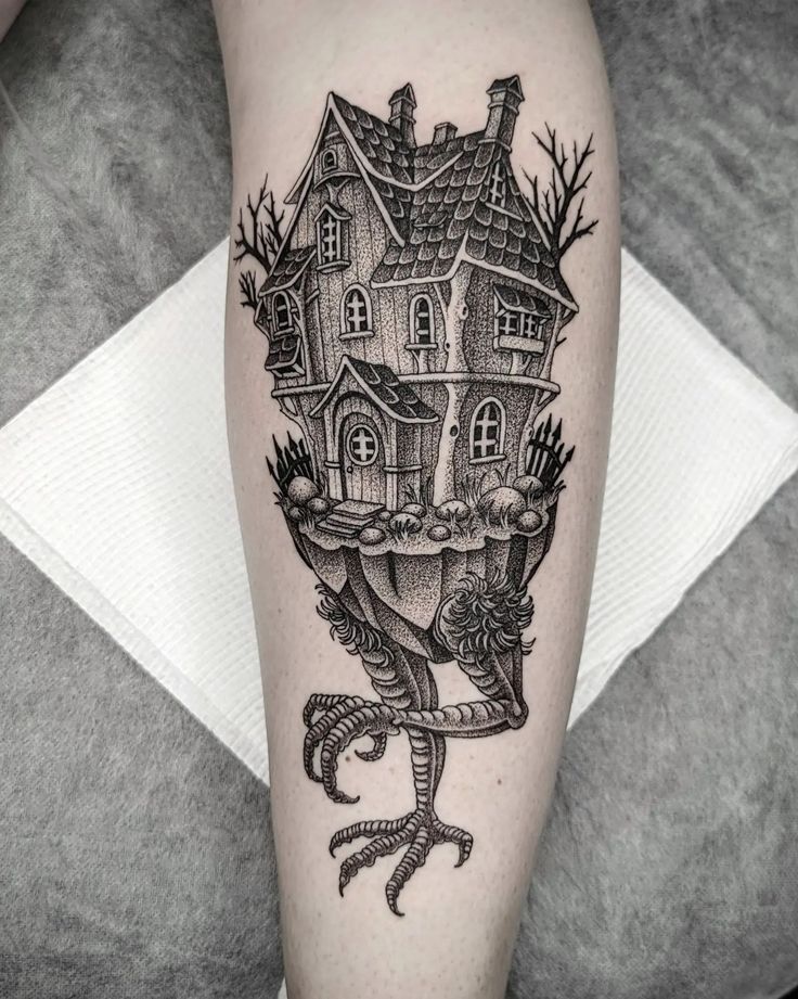 a black and white tattoo with a house on it