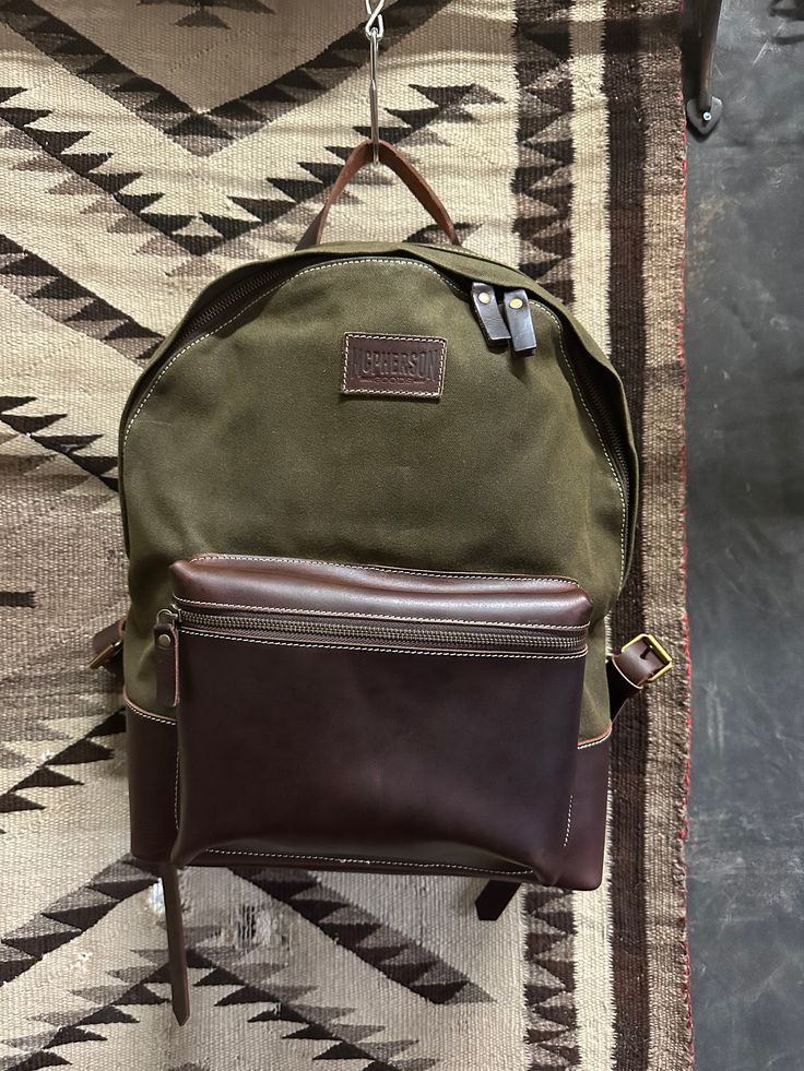 Durable backpack made of waxed canvas and leather. interior has a padded divider with a compartment for a laptop or iPad. Not reinventing the wheel here. Simple, classic, rugged and made to carry all of your daily essentials. Dimensions 14"H x 12"W x 5"D Waxed Canvas Backpack, Durable Backpack, Classic Backpack, Canvas Backpack, Waxed Canvas, Daily Essentials, Leather Interior, Divider, Ipad