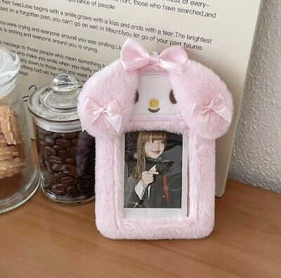 there is a pink frame with a picture on it next to some cookies and candies