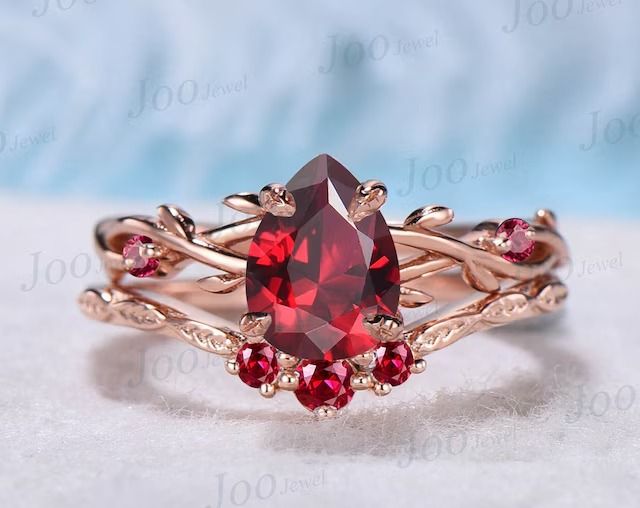 an image of a ring with red stones on it