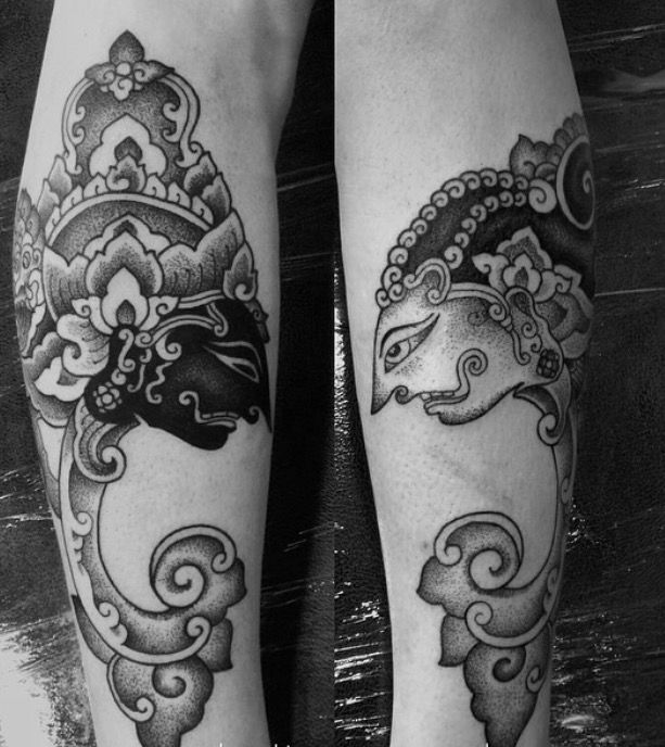 black and white photo of two legs with tattoos on them, one is wearing a crown