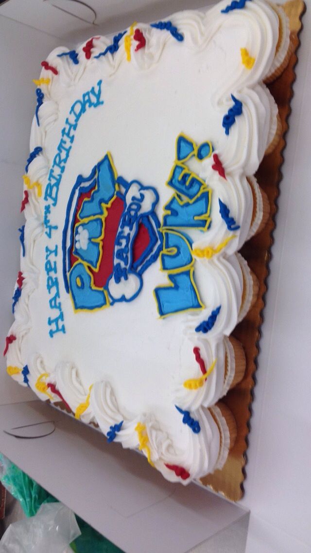 a birthday cake with white frosting and blue, red, and yellow icing