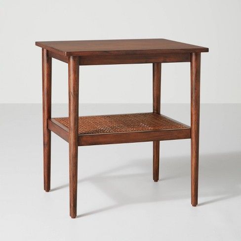 a small wooden table with one shelf on the side