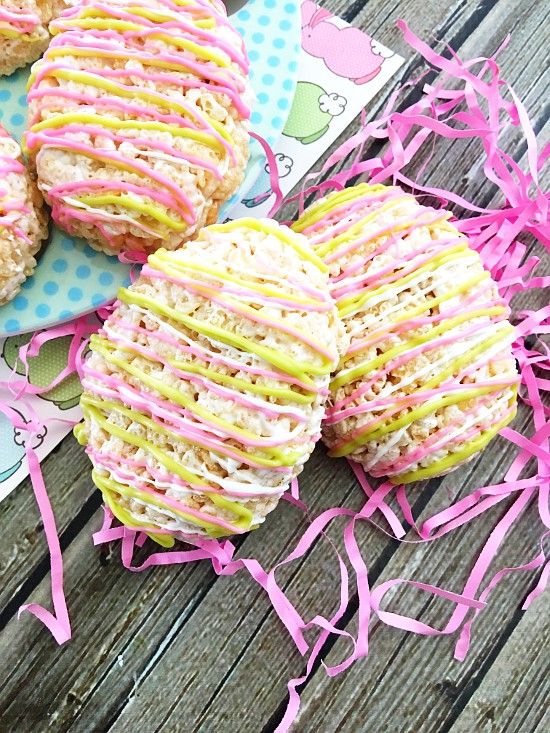 some cookies that are sitting on top of a table with pink streamers around them