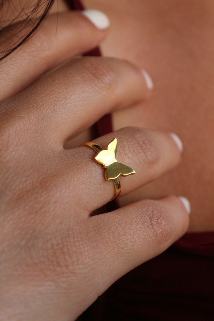 🦋 Explore Our Charming Minimalist Butterfly Ring! 🦋 Elevate your style with this adorable piece crafted from high-quality materials ✨ Choose from 925K Sterling Silver, available in Gold, Rose Gold, or White Gold finishes. Perfect for anyone seeking beauty in simplicity 💙 Details: * Crafted from 925K Sterling Silver, plated with 14K Gold, Rose Gold, or White Gold * Adjustable sizing for a perfect fit * Swift shipping ensures prompt delivery 🚚 * Our commitment to quality ensures durability for Minimalist Adjustable Butterfly Ring, Adjustable Minimalist Butterfly Open Ring, Adjustable Gold-colored Sterling Silver Butterfly Ring, Minimalist Adjustable Gold Butterfly Ring, Modern Midi Rings In Recycled Gold As Gift, Modern Recycled Gold Midi Rings As Gift, Modern Recycled Gold Midi Rings Gift, Gold Sterling Silver Butterfly Ring, Modern 14k Gold Midi Rings For Gift