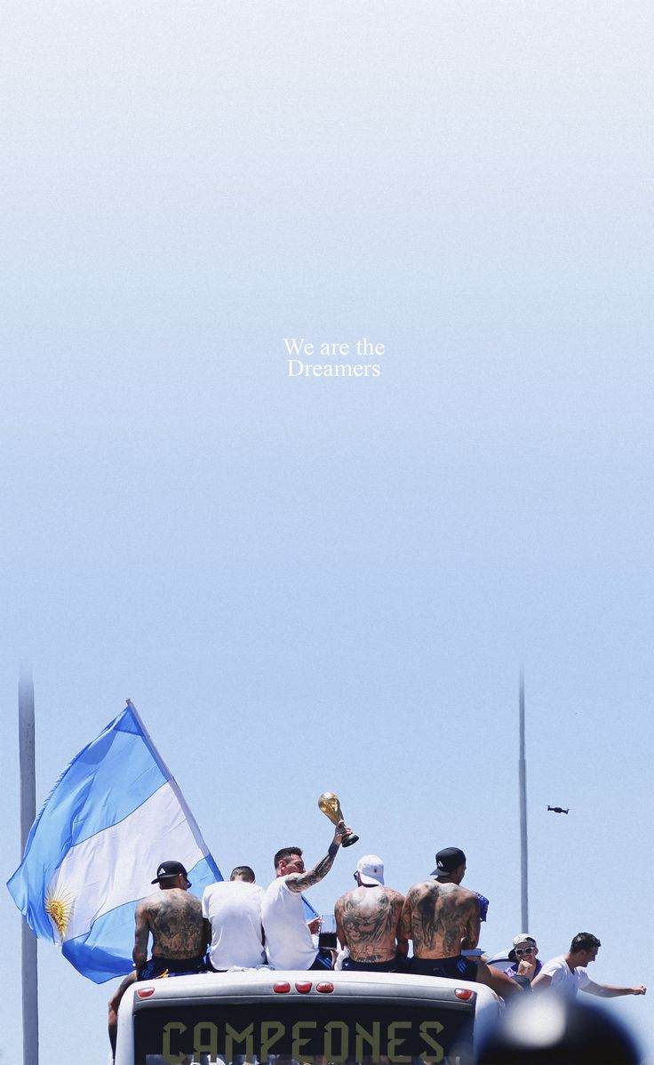 a group of men riding in the back of a truck with an argentina flag on it