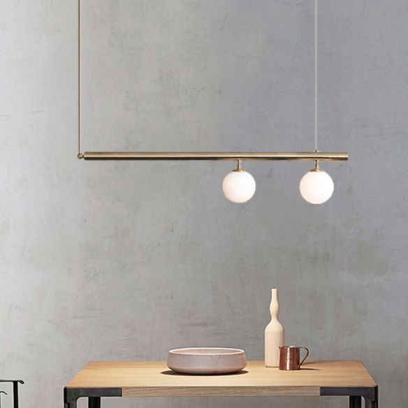 a wooden table with two lights hanging from it's sides and a white bowl on top