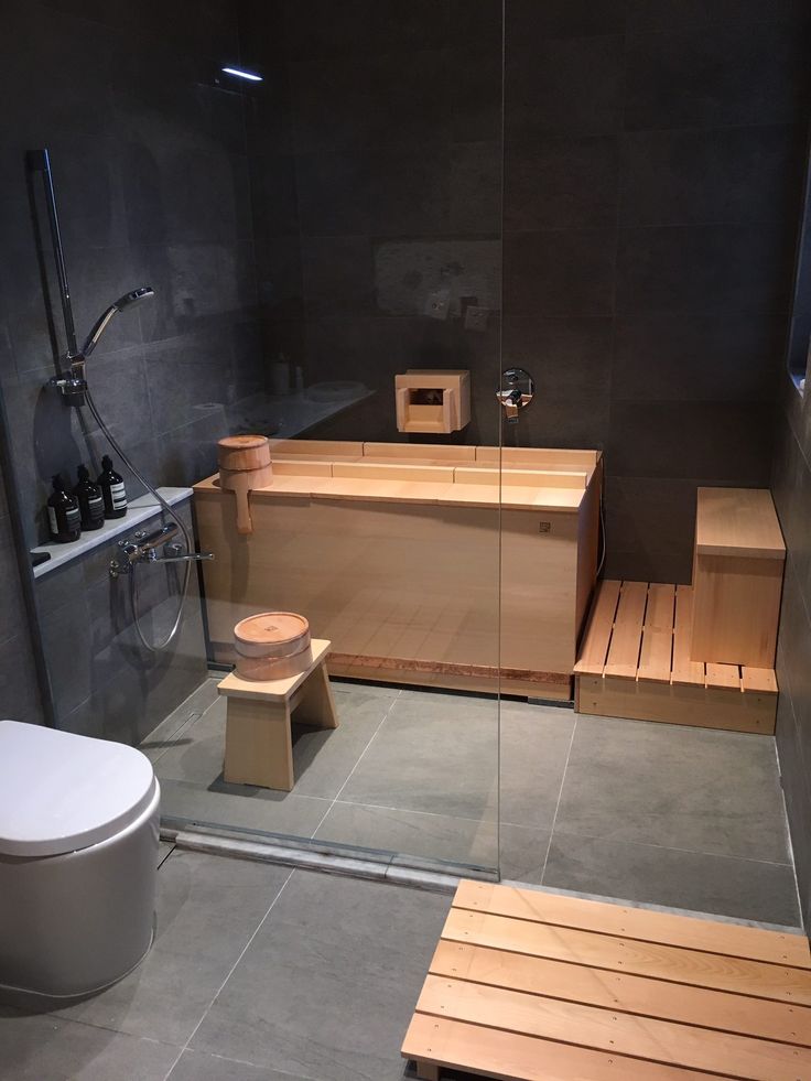 a bathroom with a wooden bench and toilet