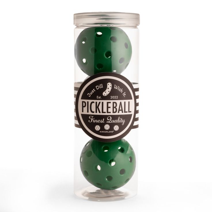 three green balls in a glass jar with the label pickleball finest quality on it