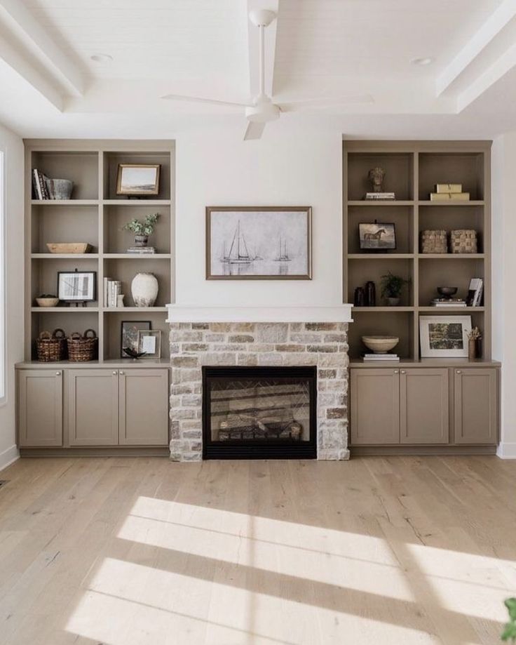 a living room with a fire place and bookshelves