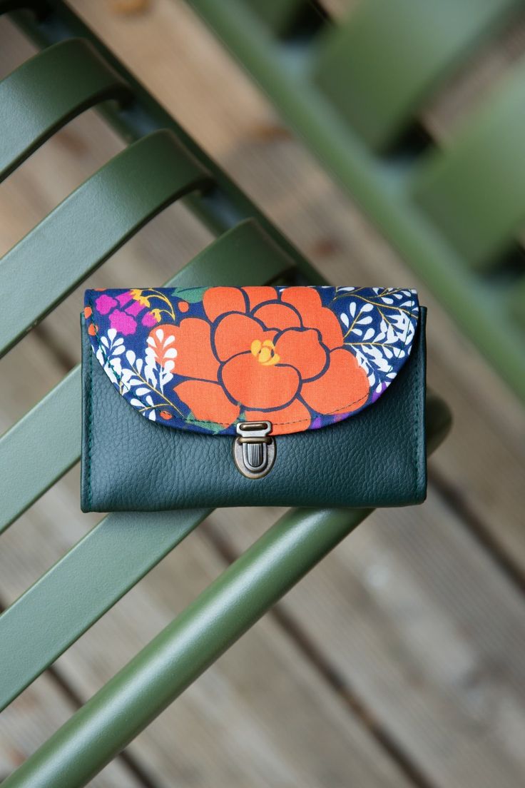 Women's purse attaches Camille schoolbag in pine green imitation leather and multicolored flower printed fabric Practical due to its small and roomy size, the gusseted coin purse is organized: - 4 compartments including one zipped - Closure with a satchel clip - Coins, notes, identity cards, loyalty cards, all your papers will find their place in this compact wallet - Bi material: imitation leather (waterproof!) and printed cotton fabric - Dimensions: height 9.5 cm and width 14 cm. * In the same Green Satchel With Removable Pouch For School, Green Coin Purse With Card Slots For Daily Use, Green Leather Bags With Card Slots, Green Satchel With Removable Pouch As Gift, Green School Satchel, Green Pouch Bag With Card Slots, Green Leather Coin Purse Pouch, Green Coin Purse With Card Slots For Travel, Green Leather Wallet With Removable Pouch