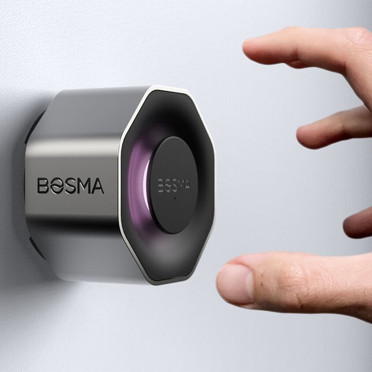 a hand is pressing the button on a wall mounted device that says bosma