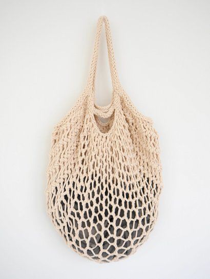 a beige bag hanging on the wall