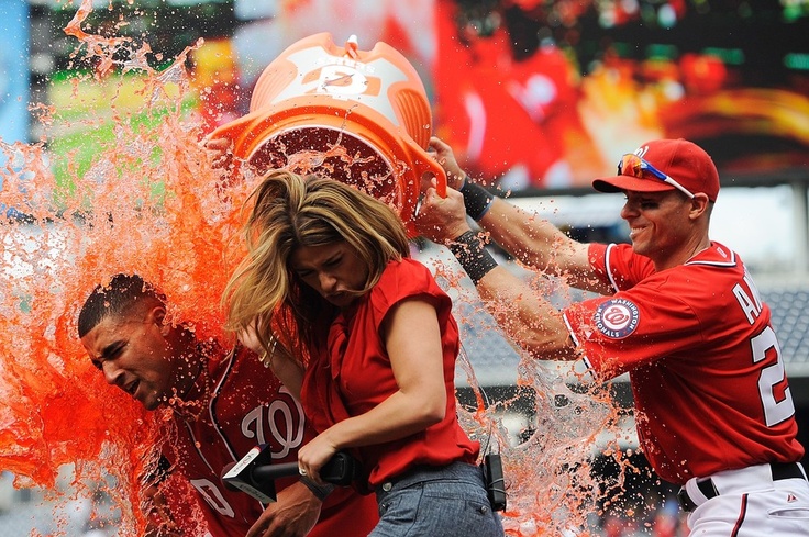 some baseball players are spraying water on each other