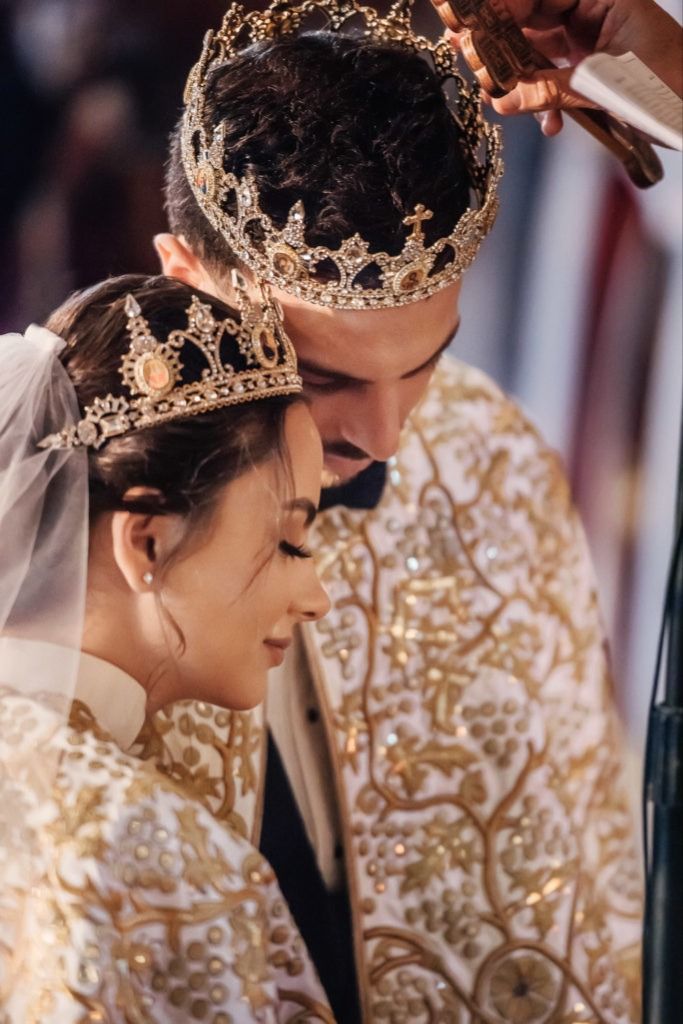 the bride and groom are wearing crowns