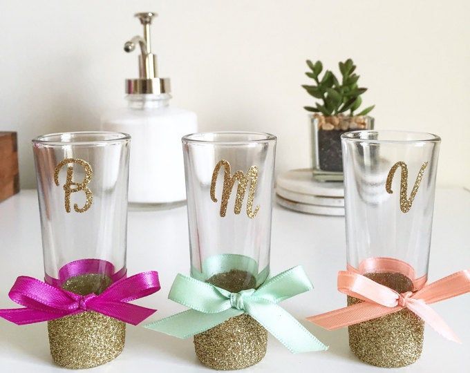 three personalized tumblers with bows on them are sitting on a white countertop