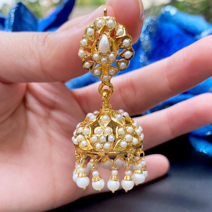 Featured are a pair of pearl Jhumkis made in 92.5 gold plated silver. All pearls used are precious freshwater pearls. The Jhumkis are comfortable to wear, weighing about 25gms. Pearl Drop Jhumkas For Festivals, Festive Pearl Jhumkas With Pearl Drop, Diwali Pearl Chandbali Jhumkas, Bollywood Pearl Chandbali Jhumkas, Festival Pearl Jhumkas With Pearl Drop, Bollywood Pearl Jhumkas For Festivals, Pearl Chandbali Temple Jewelry Jhumkas, Pearl Chandbali Jhumkas In Temple Jewelry Style, Pearl Chandbali Temple Jhumkas