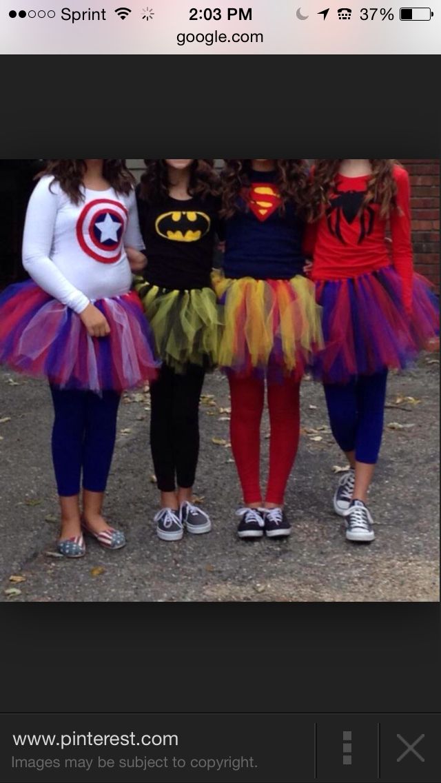 three girls dressed up in costumes for halloween