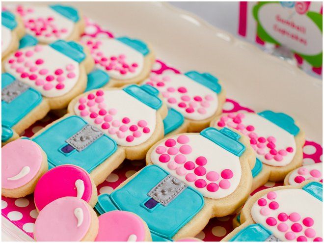 decorated cookies with pink and blue frosting on a tray