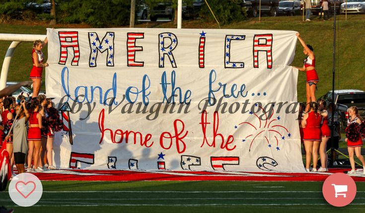 some cheerleaders are holding up a large sign