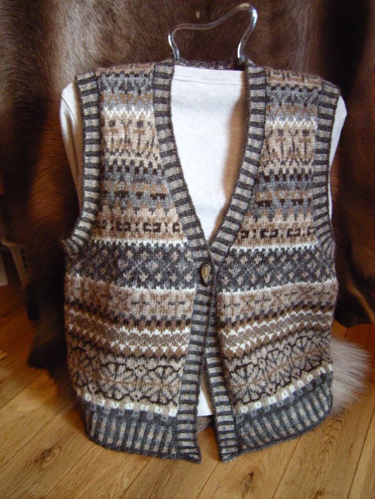 a knitted vest hanging on a wooden floor