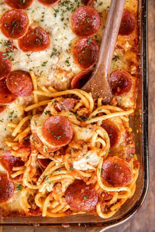 a pizza casserole with pepperoni, cheese and sauce in a baking dish