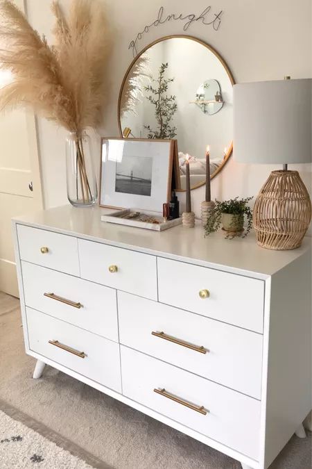 a white dresser topped with lots of drawers