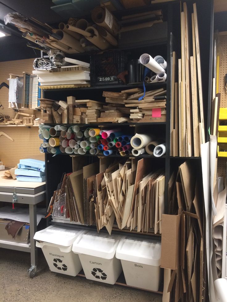 a room filled with lots of different types of wood and paper on shelves next to bins