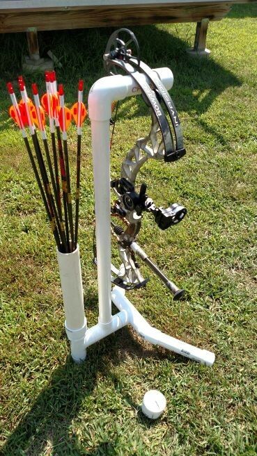 an archery set up in the grass with arrows