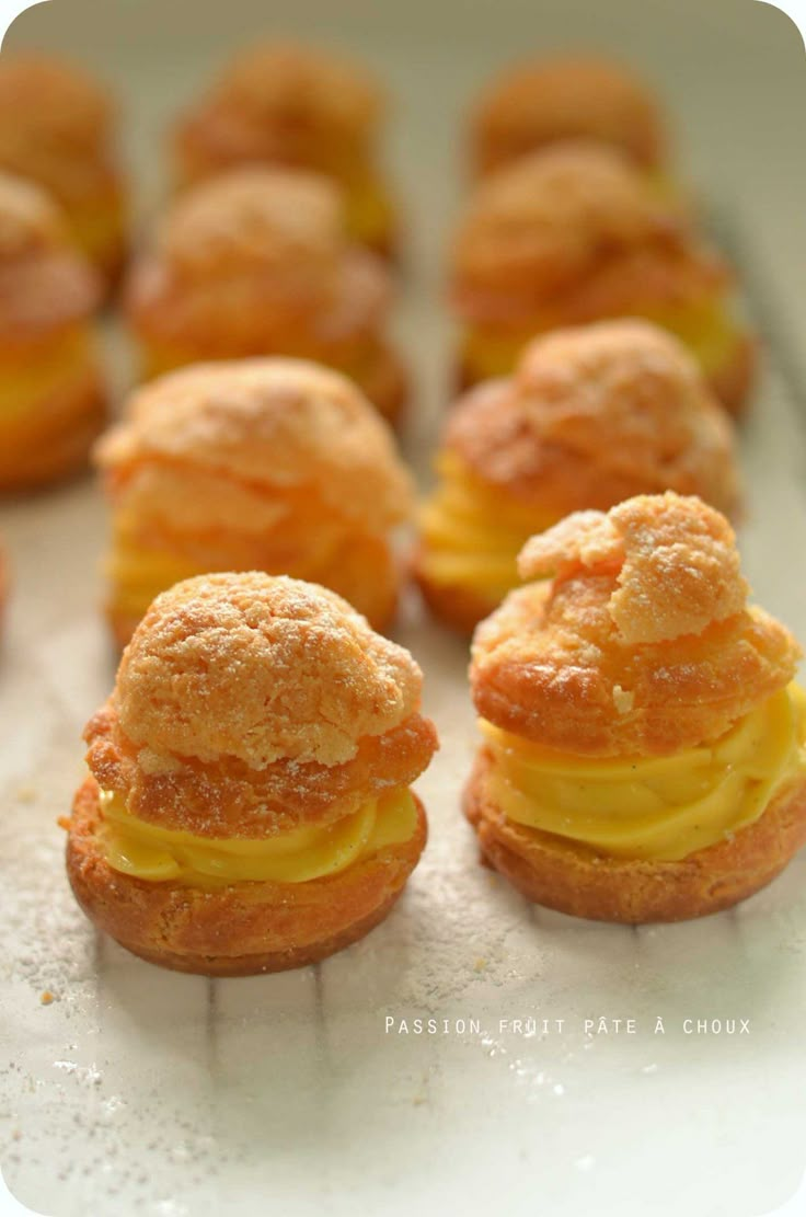 small pastries are arranged in rows on a baking sheet, ready to be eaten