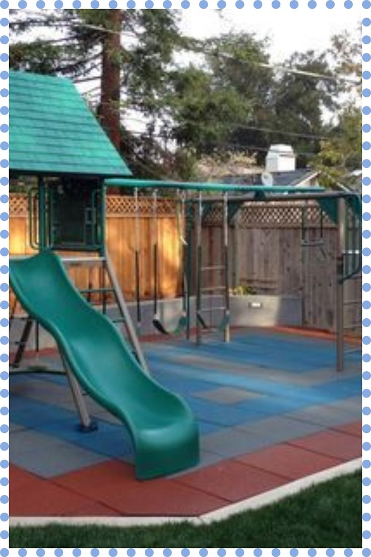 a green slide in the middle of a play area